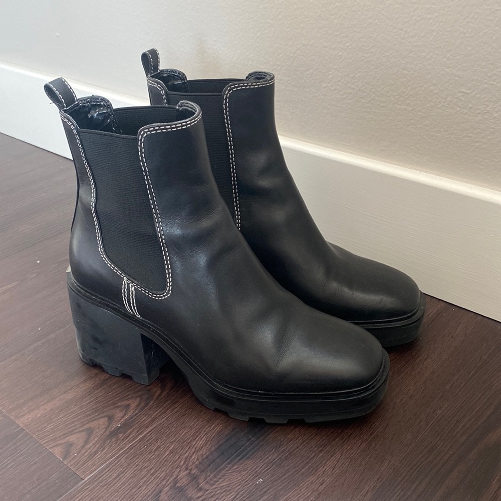 Michael Kors black booties with white stitching.